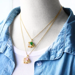 Detail of cute elephant pendant necklaces with vibrant gemstones and pearl accents
