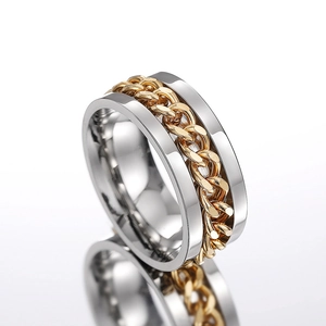 Close-up of rotatable golden Cuban chain inlay on a polished silver stainless steel ring