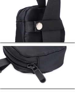 Macro view of durable black nylon fabric with silver metal snap and alloy zipper detail