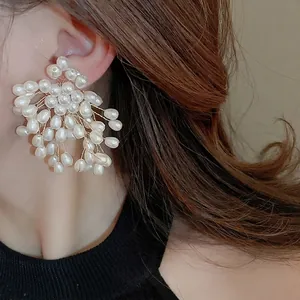 Elegant floral pearl drop earrings featuring cluster design and vintage gold wire finish