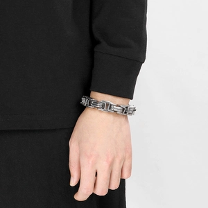 Silver stainless steel Byzantine chain bracelet for men worn on a wrist in a lifestyle view