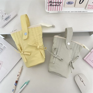 Vertical canvas pencil case in yellow and green with bows and top handle detail