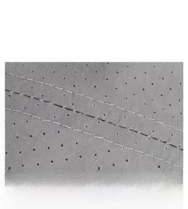 Detail of dark grey breathable mesh fabric with perforated holes and durable double stitching