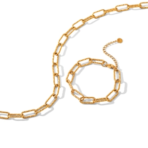 Gold paperclip link necklace and bracelet set in textured stainless steel on white back
