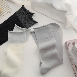 Detailed set of three ballet-style crew socks in black, mint green, and grey tones