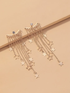 Detailed close-up of gold star tassel earrings with elegant sparkling zircon accents
