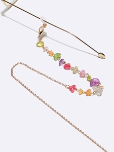 Detail of colorful natural stones and gold metal chain for eyewear and masks