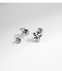 Close-up of S925 sterling silver star stud earring with a clear hallmark stamp