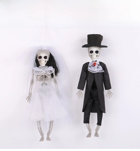 Detail of Halloween skeleton bride and groom hanging decorations with lace costumes