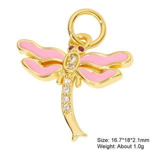 Detail view of a gold dragonfly pendant with pink enamel wings and zircon inlay