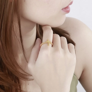 Creative gold-plated titanium cross ring with twisted rope band shown on a finger