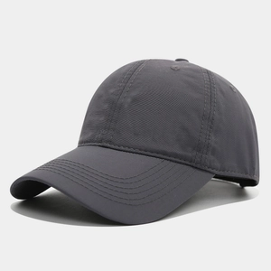 Detail view of the charcoal grey quick-dry baseball cap with reinforced stitched brim