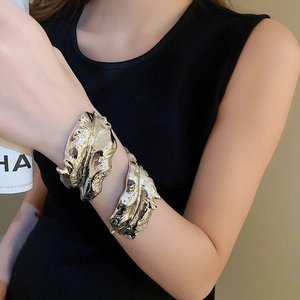 Detailed close-up of a silver metallic leaf bracelet with unique crinkled leaf texture