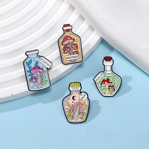 Set of four pastel enamel mushroom potion bottle brooches with magical text engravings