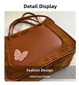 Detailed close-up of brown plush tote bag featuring leather patch and butterfly embroidery