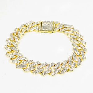 Detailed close-up of 20MM gold plated Cuban link chain encrusted with shiny rhinestones
