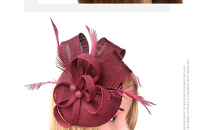 Detail of burgundy mesh veil fascinator with elegant feathers for bridal tea parties