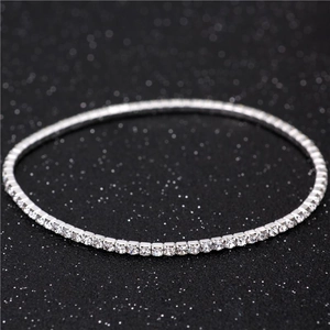 Detailed view of single-row 2mm silver elastic tennis bracelet with sparkling clear crystals