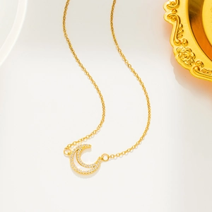 Titanium steel moon necklace with diamonds and mother of pearl on a white surface