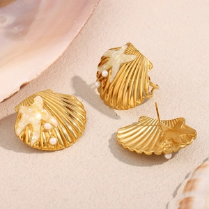 18K gold plated starfish and shell stud earrings with pearls on a beach sand background