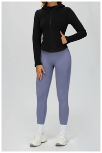 Front view of slim fit hooded fleece jacket with high waist leggings and white sneakers