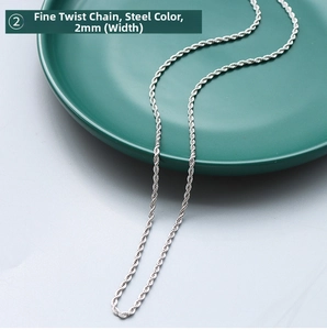 Detail view of 2mm silver-tone stainless steel rope chain on elegant dark green plate
