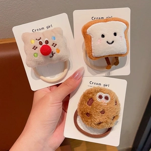 Cute plush cartoon toast and cookie hair scrunchies set on a white display card