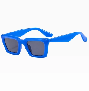 Detail view of bold royal blue square sunglasses with thick frames and dark lenses