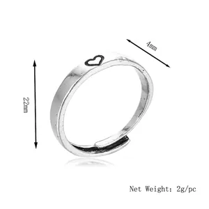 Minimalist silver adjustable open ring featuring a black heart pattern, 22mm diameter
