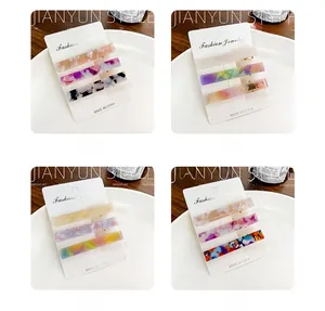 Three-piece acetate hair clip set with marble and tortoise shell patterns on display card