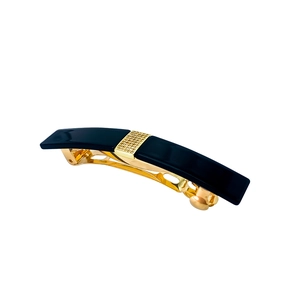 Detailed view of elegant acetate hair clip with gold metal base and pavé diamond inlay