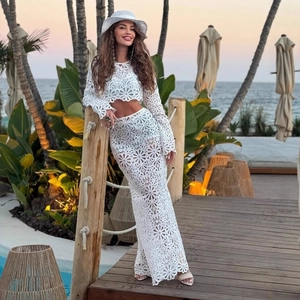 Detailed white crochet lace two-piece set featuring long sleeve crop top and maxi slit skirt