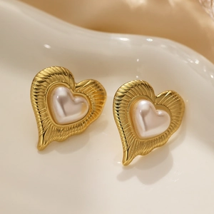 Vintage 18k gold plated heart earrings with pearl inlay on a white ceramic tray