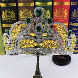 Detailed close-up of a silver bridal tiara featuring yellow and green cubic zirconia