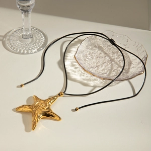 Vintage 18k gold plated stainless steel starfish pendant on a black cord necklace