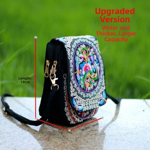 Detailed view of black ethnic crossbody bag with floral embroidery and 19x14x8cm size