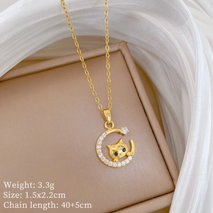 Detailed specs of moon and cat pendant necklace with gold finish and blue stones