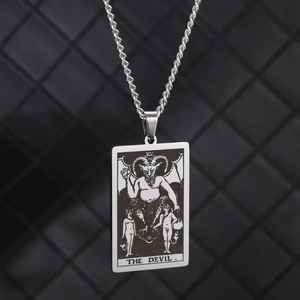 Detailed close-up of stainless steel The Devil tarot card pendant on a thick rope chain