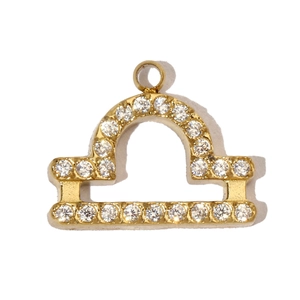 Detail of Libra zodiac gold pendant with micro-paved cubic zirconia on white background