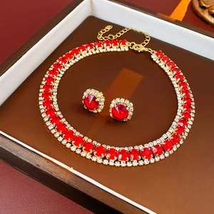 Detail of red square rhinestone necklace and matching earrings set in elegant jewelry box