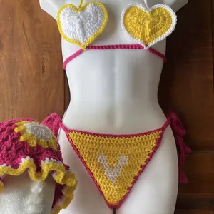Detailed view of handmade three-piece crochet heart bikini set with matching sun bucket hat
