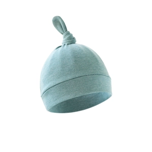 Soft grey-blue newborn cotton knit beanie with top knot detail on a white background