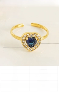 Detail of 18K gold plated steel ring with blue heart zircon and white diamond halo