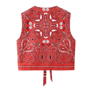 Detailed back view of red paisley print puffer vest featuring decorative tie straps