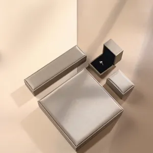 Elegant grey satin jewelry box set with necklace, ring, and pendant organizers in luxury style