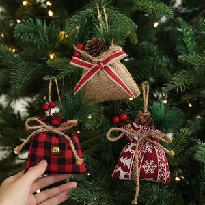 Christmas burlap gift bag ornaments set with pine cones and berries on a tree