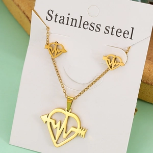 Macro view of gold stainless steel necklace and earrings set with heartbeat star design