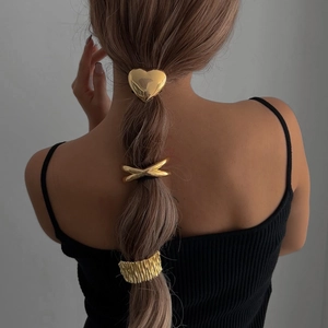 Three-piece gold geometric metal hair rings set including heart and knot styles