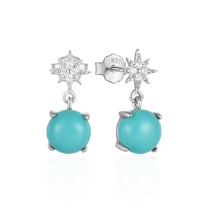 Detail of S925 sterling silver star earrings with turquoise beads and mirror reflection