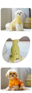 Detailed view of colorful quilted dog coats with hoods and cute cartoon patches for pets